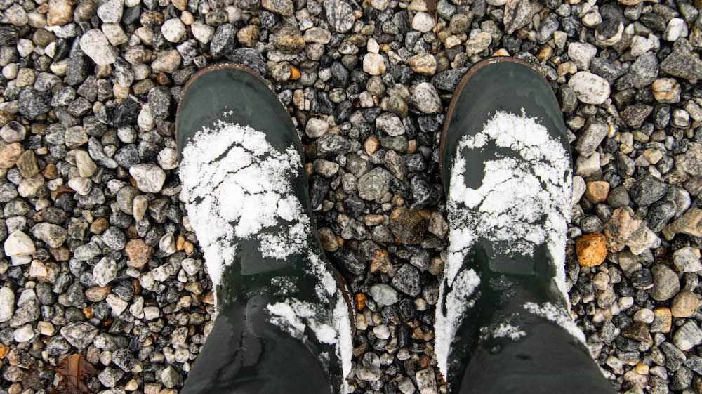 Rubber boots covered with snow 