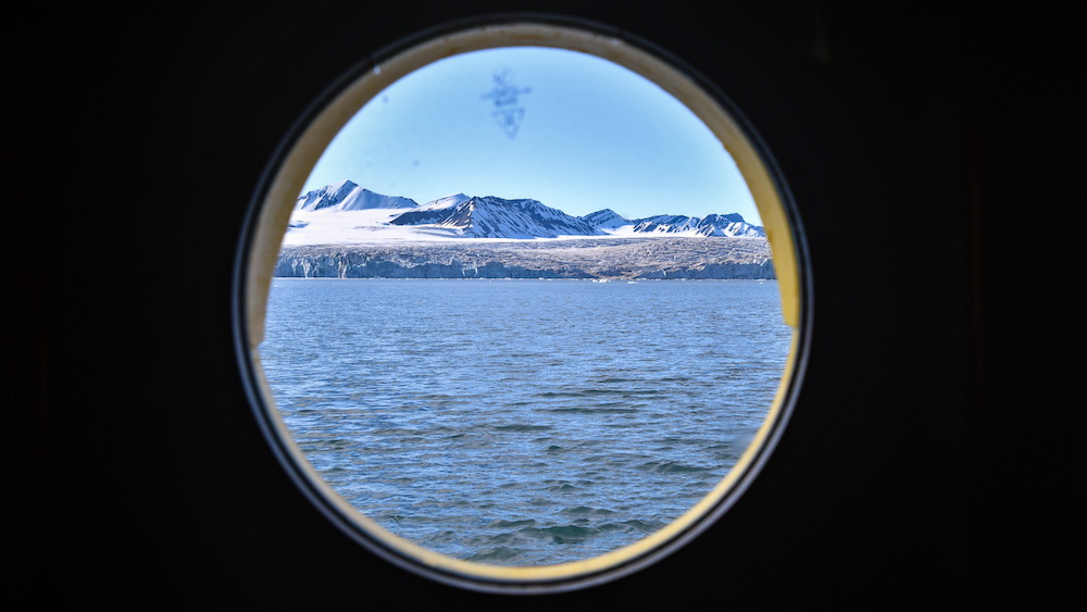 View through a porthole at a glacier