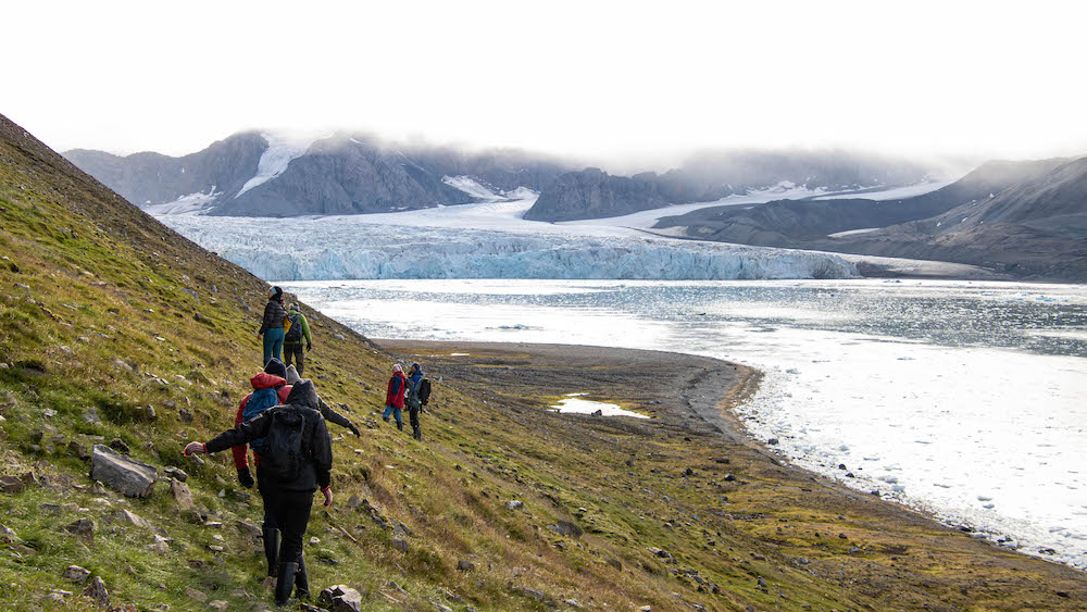 Several people on their way to a glacier