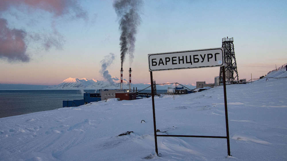 Barentsburg town sign against a mountain backdrop
