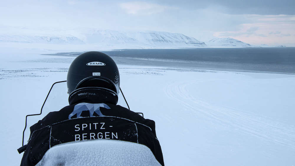 Person on a snowmobile tour on Svalbard